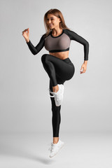 Sexy athletic girl jumping, working out. Fitness woman training