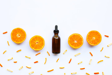 Essential oil with citrus fruits on white