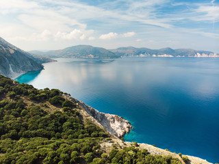 Fototapeta na wymiar Scenic aerial view of picturesque jagged coastline of Kefalonia with clear turquoise waters, surrounded by steep cliffs.