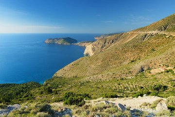 Scenic aerial view of picturesque jagged coastline of Kefalonia with clear turquoise waters, surrounded by steep cliffs.