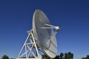 Array of satellite dishes or radio antennas against sky. Space observatory.