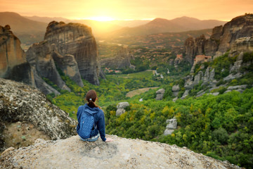 Female tourist exploring Meteora valley, a rock formation in central Greece hosting one of the largest complexes of Eastern Orthodox monasteries.