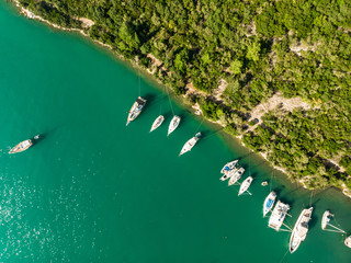 Aerial view of Nidri port with plenty of boats and yachts. Coast of Lefkada island on sunny summer day.