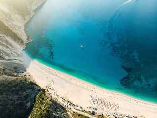 Fototapeta na wymiar Aerial top down view of Myrtos beach, the most famous and beautiful beach of Kefalonia, a large coast with turqoise water and white coarse sand, surrounded by steep cliffs.