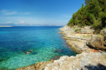 Scenic view of Emplisi Beach, picturesque stony beach in a secluded bay, with clear waters popular for snorkelling. Small pebble beach near Fiscardo town of Kefalonia, Greece.