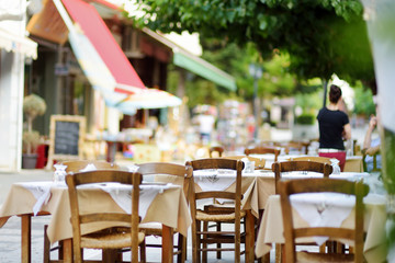 Small outdoor restaurants at the pedestrian area at center of Kalavryta town near the square and odontotos train station, Greece.