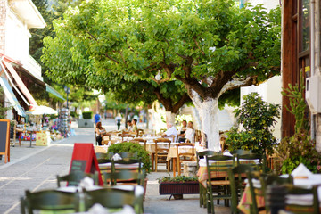 Small outdoor restaurants at the pedestrian area at center of Kalavryta town near the square and odontotos train station, Greece.