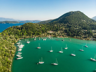 Aerial view of Nidri port with plenty of boats and yachts. Coast of Lefkada island on sunny summer day.