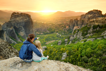 Mother and daughter exploring Meteora valley, a rock formation in central Greece hosting one of the largest complexes of Eastern Orthodox monasteries.