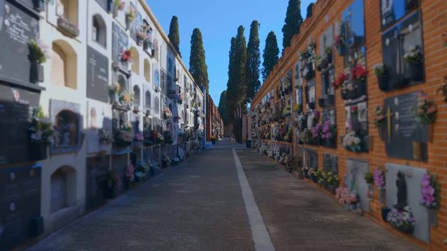 Municipal Columbarium in Spain with its attributes - the places where urns with ashes, wreaths, flowers, sculptures, monuments, plates with carved symbols and memorable inscriptions are kept