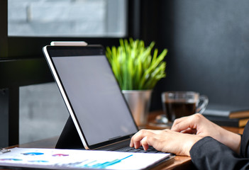 Business people working on laptop computer on wood desk in office.