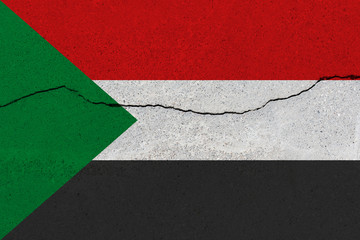 sudan flag on concrete wall with crack
