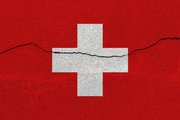Switzerland flag on concrete wall with crack