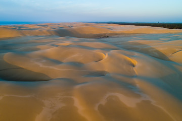 Fototapeta na wymiar Aerial landscape of beautiful sand dunes at sunrise. Anna Bay, New South Wales, Australia