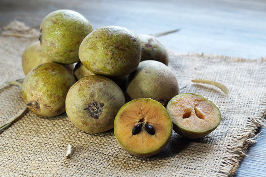 sawo fruit (manilkara zapota) commonly known as sapodilla fruit on burlap bacground