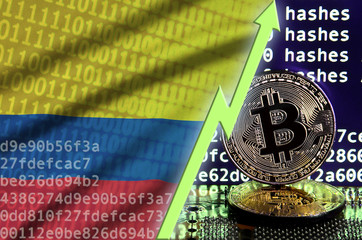 Colombia flag and rising green arrow on bitcoin mining screen and two physical golden bitcoins