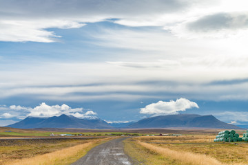 The road to volcanic mountain. Beautiful perspective view rural scene landscape in  west Iceland.