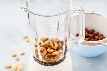 Blender and almonds soaked in water. Making vegan milk.