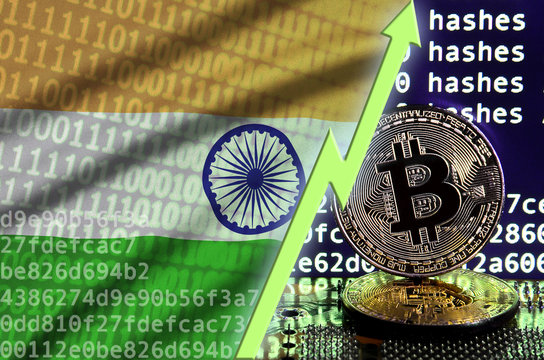 India flag and rising green arrow on bitcoin mining screen and two physical golden bitcoins