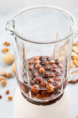 Blender with soaked hazelnuts for making nut milk.