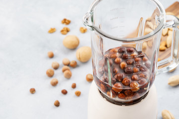 Soaked hazelnuts in blender. Making vegan nut milk.