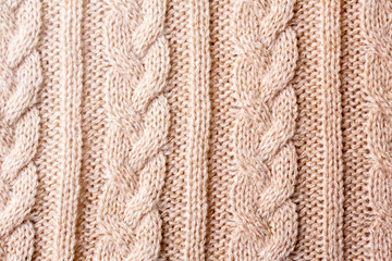 冬物衣類　ベージュピンクの縄編みニットのテクスチャ　パターン
