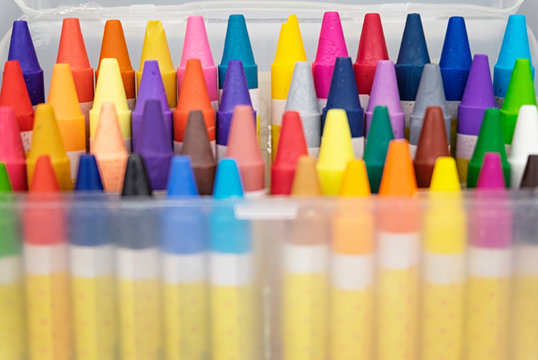 education and back to school concept, colorful crayons in the transparent box.selective focus shot and grain effect