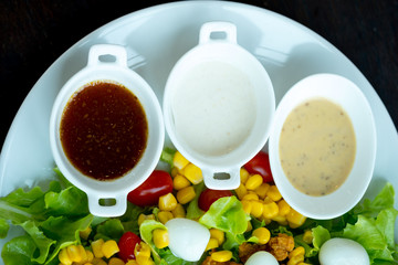 Different of dressing salad in white bowl