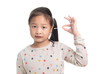 Cute kid southeast asian girl age 7 years in acting with cotton bud isolated on white