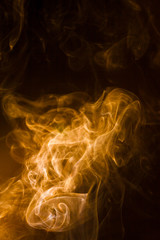 Gold smoke on black background.