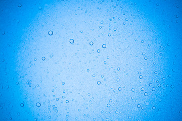 Rain droplets on blue glass background, Water drops on glass.