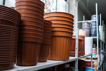 Set of multi-colored empty pots for plants. The brown pots put by a pile. Flowerpots for houseplants