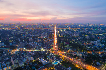 Fototapeta premium Aerial view sunset in Bangkok city building with city transport road