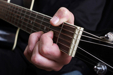 Fototapeta na wymiar Guitarist plays the guitar. Close-up.