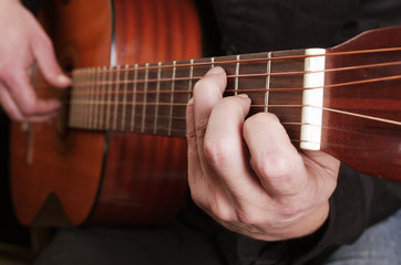 Fototapeta na wymiar Guitarist plays the guitar. Close-up.