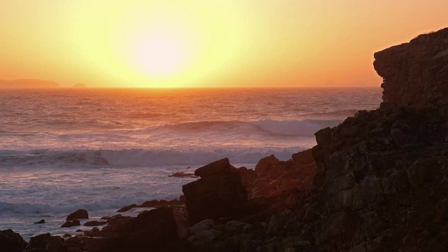 Sunset over Atlantic ocean on lheu da Papoa island near Peniche peninsula in Portugal
