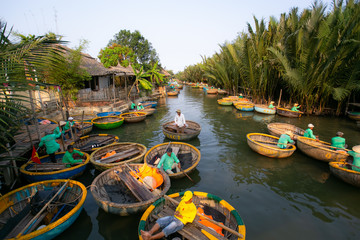 Touring the coconut palm forest on the river in bamboo basket boats - 255497803