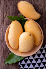 fresh yellow mangoes on kitchen table.