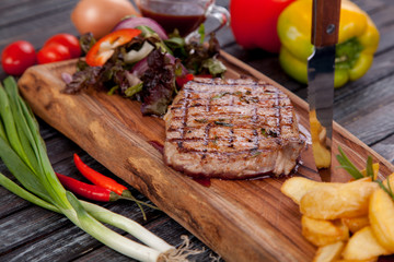 juicy and appetizing steak tamogavok of horse meat on the table, for design in cooking	