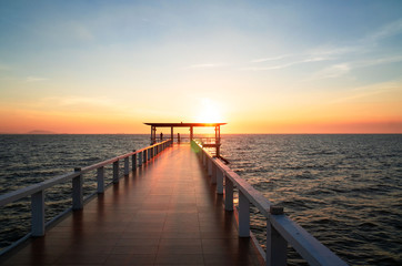 Fototapeta na wymiar Landscape of bridge in sea on tropical beach and sunset sky background .