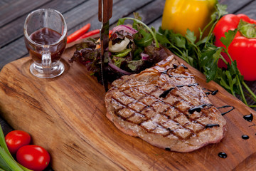 juicy and appetizing steak tamogavok of horse meat on the table, for design in cooking	