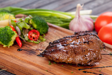 juicy and appetizing steak tamogavok of horse meat on the table, for design in cooking	