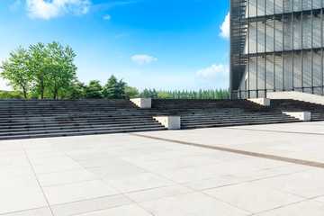 Empty square floor and green woods with office building in Shanghai