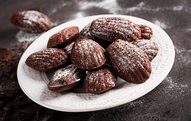 Chocolate cookies. Homemade Chocolate Madeleines on dark table. French cuisine.
