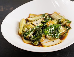 Bok choy vegetables stir fry with soy sauce and sesame seeds. Chinese cuisine.