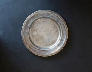 Rustic silver plate on black background