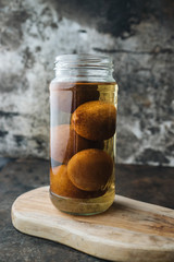 Pickled lemon on rustic background
