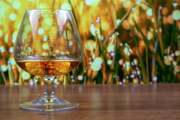 Cognac in a snifter glass with droplets of drink on the glass