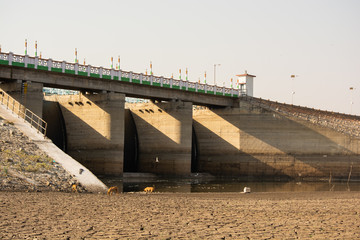 A dried up empty reservoir or dam during a summer heatwave, low rainfall and drought in north...