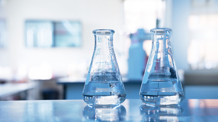 two glass flask with water in chemical science laboratory education background